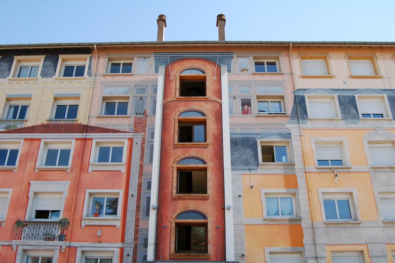 blue sky and urban building in lyon with multicolored walls and complex facade with varied windows, colorful apartment building 4k