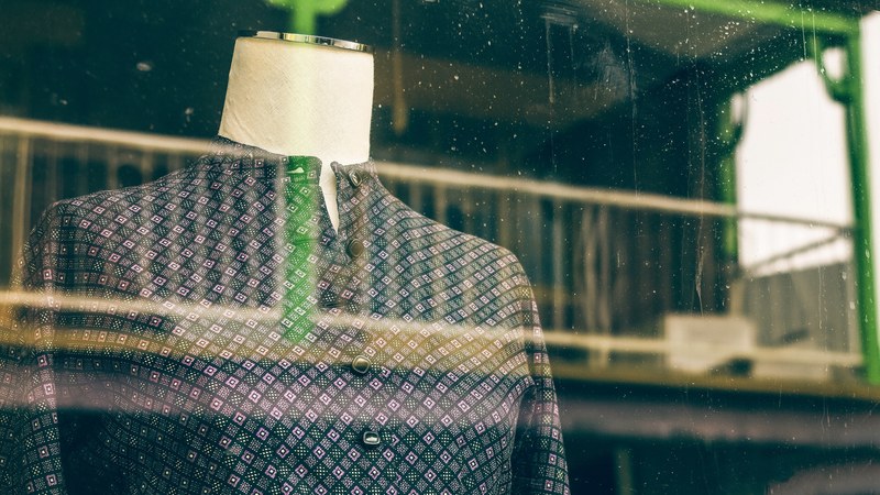 looking through a shop window at a mannequin in a dress, window shopping 4k