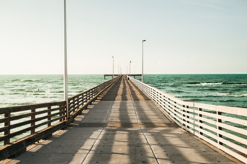 a wide wooden pier reaching out into the sea, wide ocean pier 4k