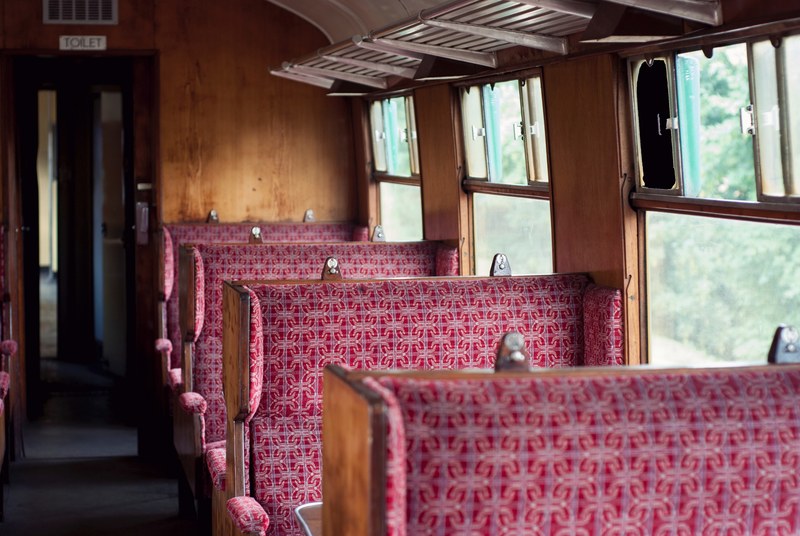 interior of the old vintage british railway passenger carriage with wooden benches in ropley, vintage british railway carriage interior 4k
