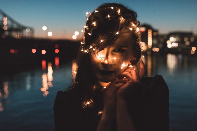 a woman with fairy lights wrapped around her head and the bokeh effect they are making in boston, light veil 4k