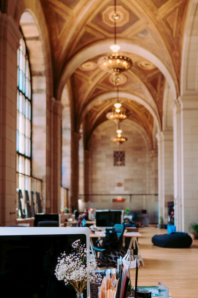 an open office space in a cathedral style interior, unsplash hq crew collective amp cafe montreal 4k