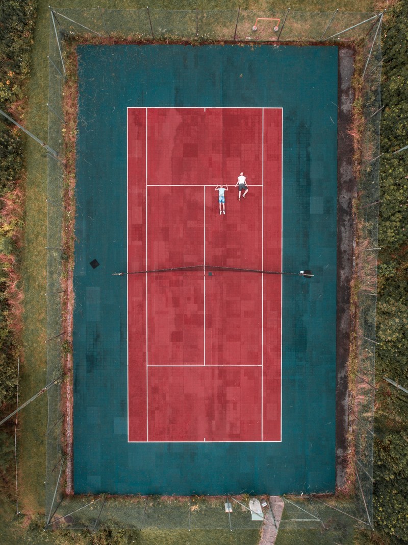 a drone looking down at an outdoor tennis court, _fitness on the tennis court 4k