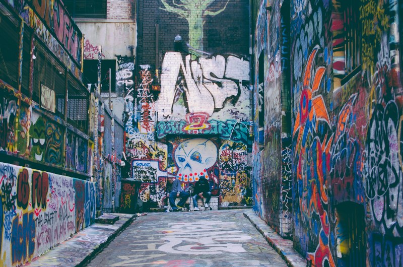 colorful grunge graffiti artwork covering walls in alleyway with skull in hosier lane, graffiti everywhere in alley 4k