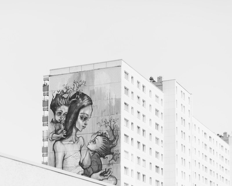 black and white mural of exhausted mother with two children on side of building in berlin, mural of mother with children 4k