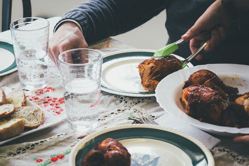 serving roast chicken and bread at a homemade dinner, sunday roast dinner 4k