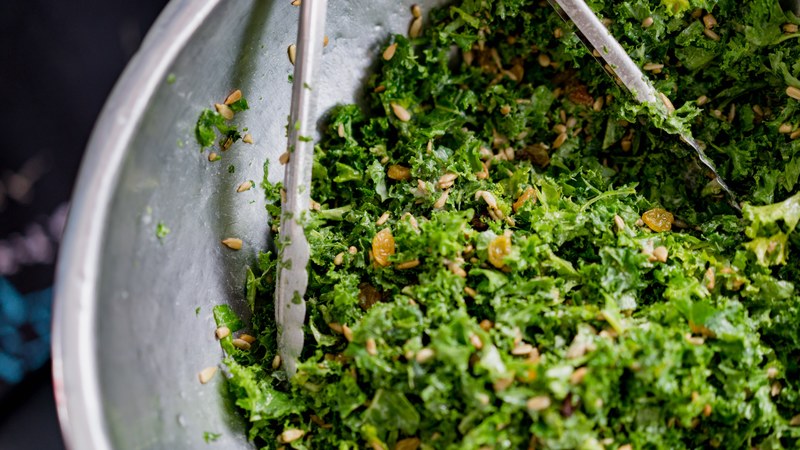 tongs toss a large bowl of fresh kale salad, kale salad 4k