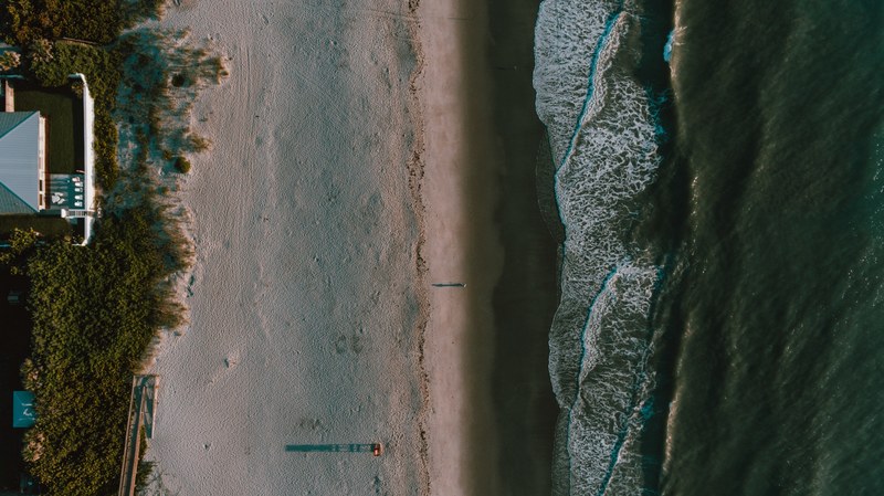 drone view of the house on the sandy coastline at melbourne beach, melbourne beach coastline 4k