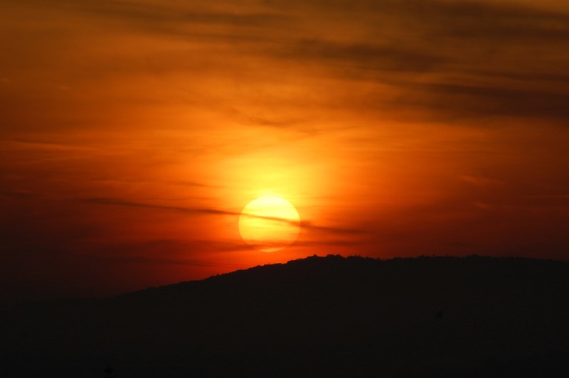 a deep orange sunset going down behind a hill at jena, jena sunset_ 4k