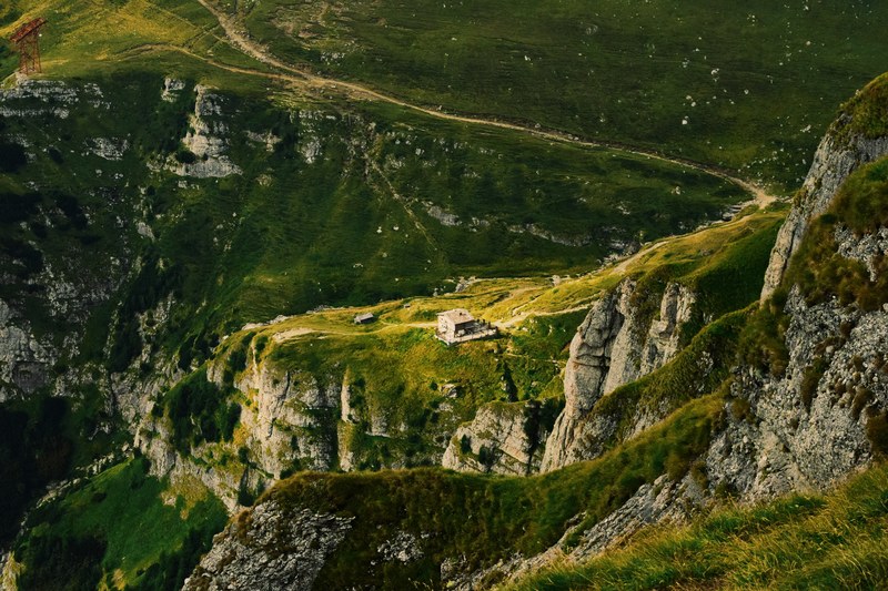isolated cabin in a green mountain landscape on the hillside, solitude 4k