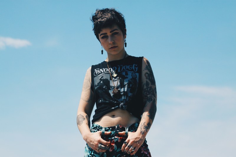 trendy woman in punk style clothes wears a snoop dogg t shirt, music and tattoos 4k