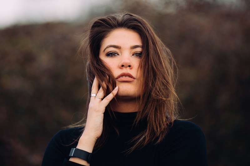 brown haired woman wearing watch while holding face to hand, springs comin 4k