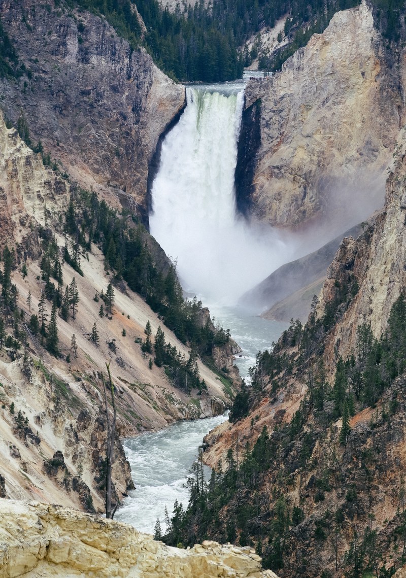 waterfall cascades over a mountain ridge in yosemite, lower falls 4k