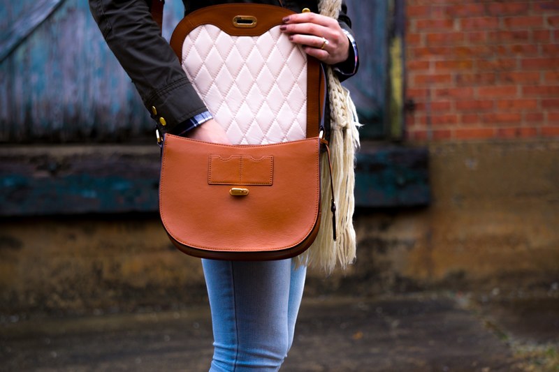 woman reaching into her fashionable purse outside, checking her purse 4k