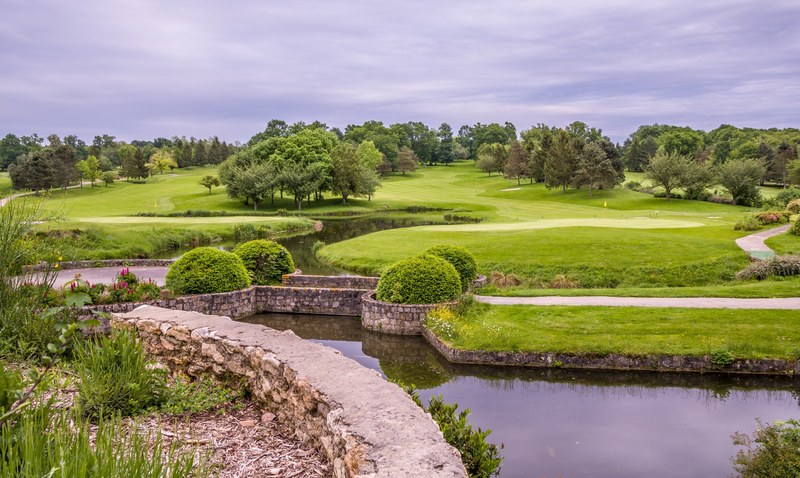 a golf course with holes by the water in cly, cly golf course 4k