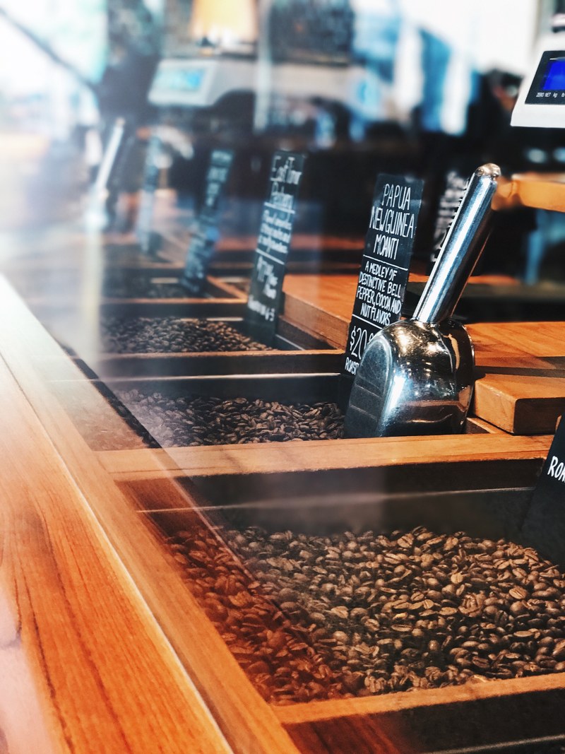 various types of roasted coffee beans displayed behind glass, coffee bean bulk starbucks 4k