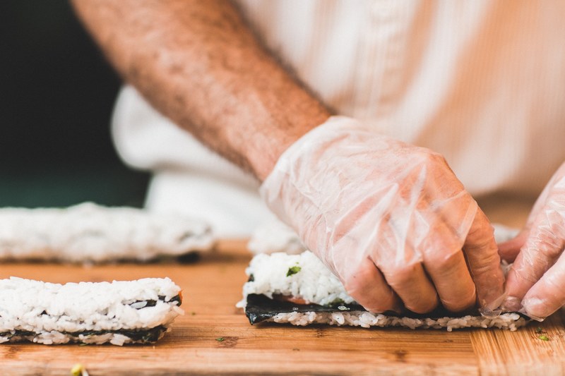 close up of a man preparing sushi on a wooden surface, sushi chef 4k
