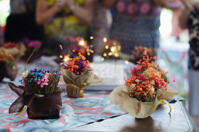 several bouquets of colorful tiny flowers decorating a table, tiny bouquets at a birthday party 4k