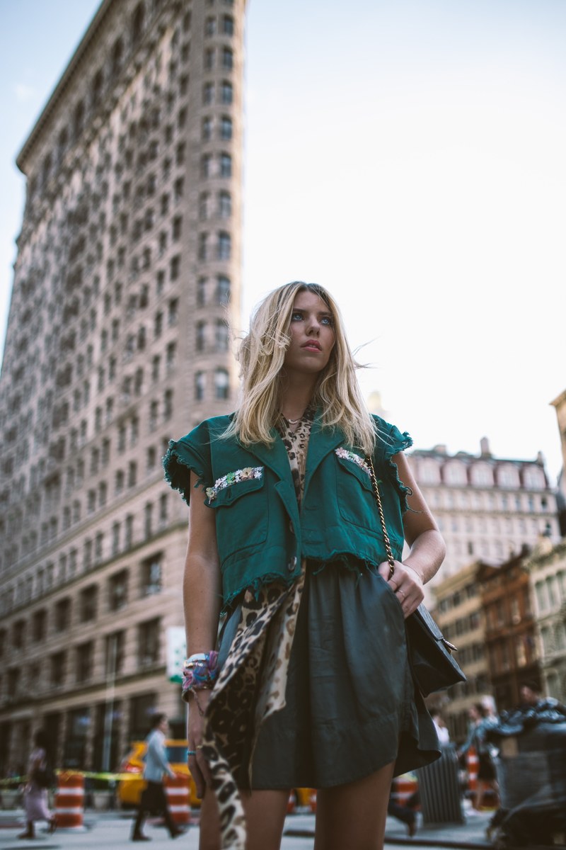 trendy woman models a blue and green outfit in the city, walks through flatiron 4k