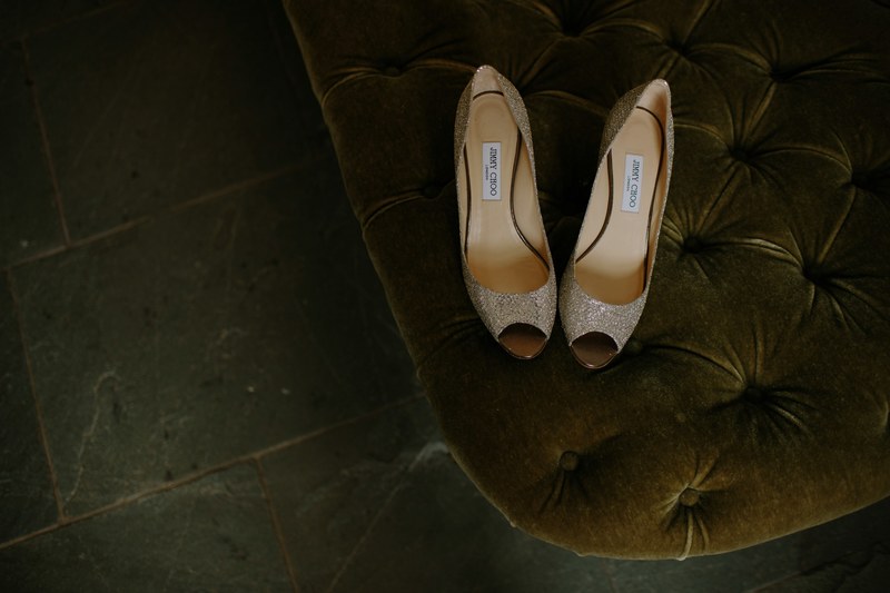 a pair of silver womens shoes sitting on a cushion, wedding shoes choo choo 4k
