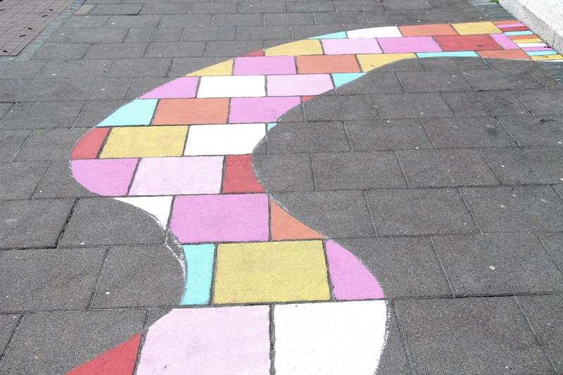 a curvy section of bricks painted with various light colors, _section of bricks painted 4k