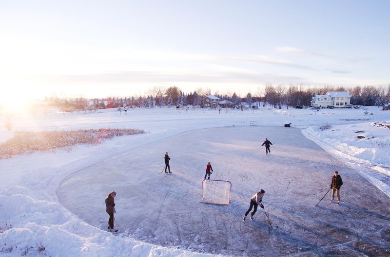 group of people playing ice hockey with one net on a frozen surface in a suburb, the game 4k