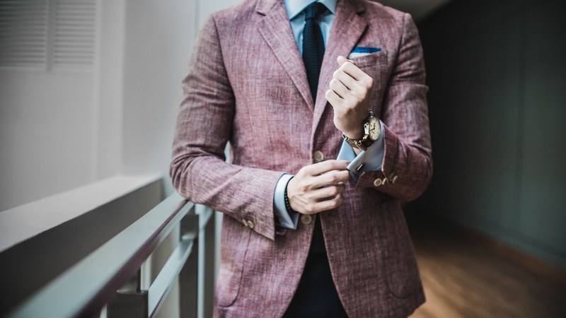 a man in a formal suit adjusting the cuffs of his shirt, business professional 4k