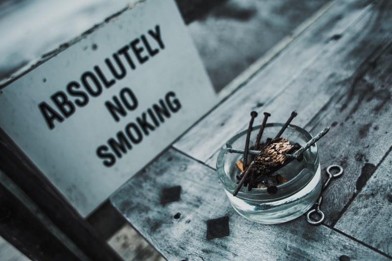 ashtray with rusty nails by a no smoking sign, no smoking 4k