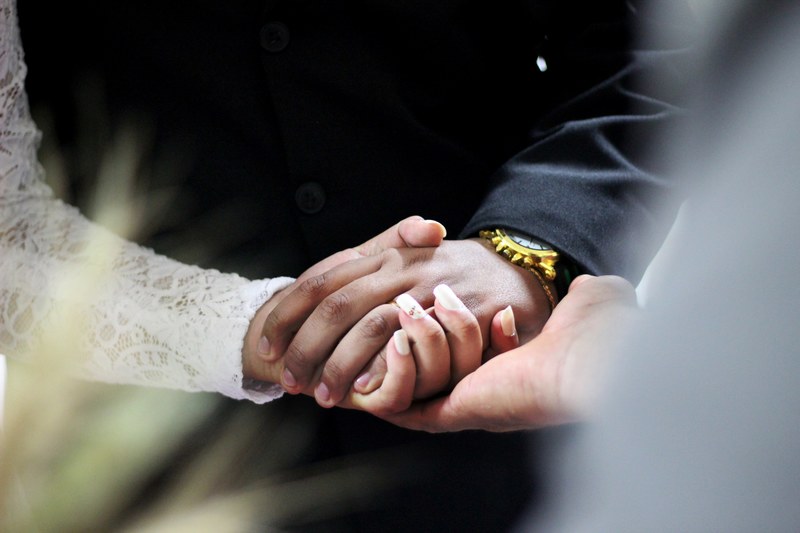 a couple holds hands as they take their vows during a wedding ceremony, _wedding couples hands 4k