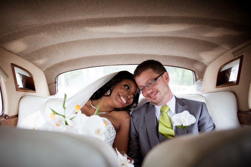 a bride and groom sitting in the backseat of a car and smiling in amsterdam, wedding of alex and cindy 4k
