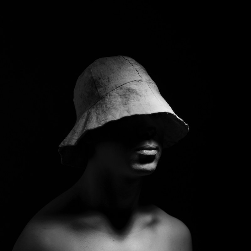 a man with a hooded hat surrounded by darkness, _hooded hat male 4k