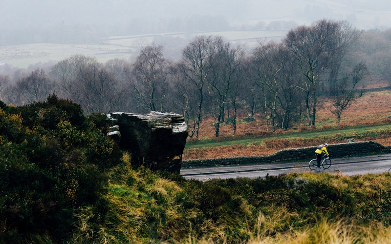 fall landscape with the cyclist cycling on the wet countryside road in the surprise view car park, surprise view owler tor 4k