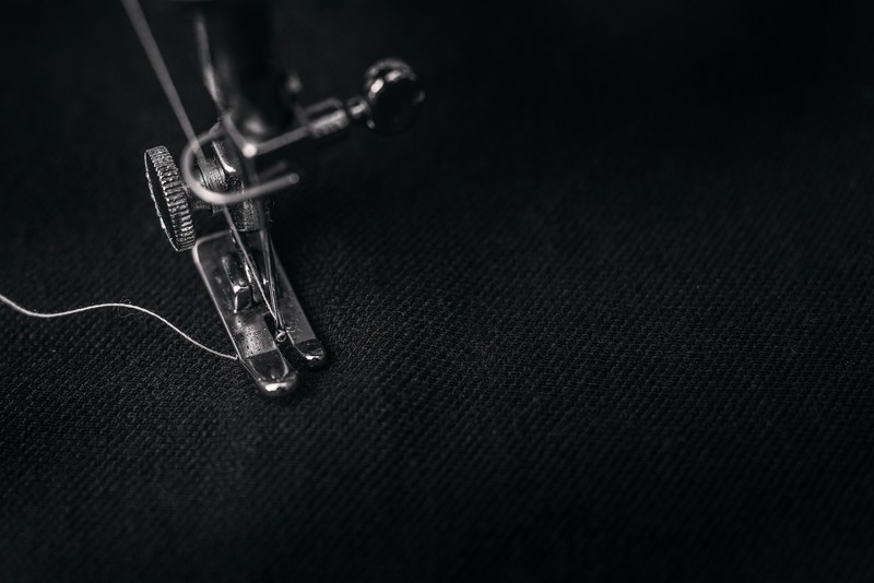 a dark black and white photo of a threaded sewing machine, sewing machine 4k