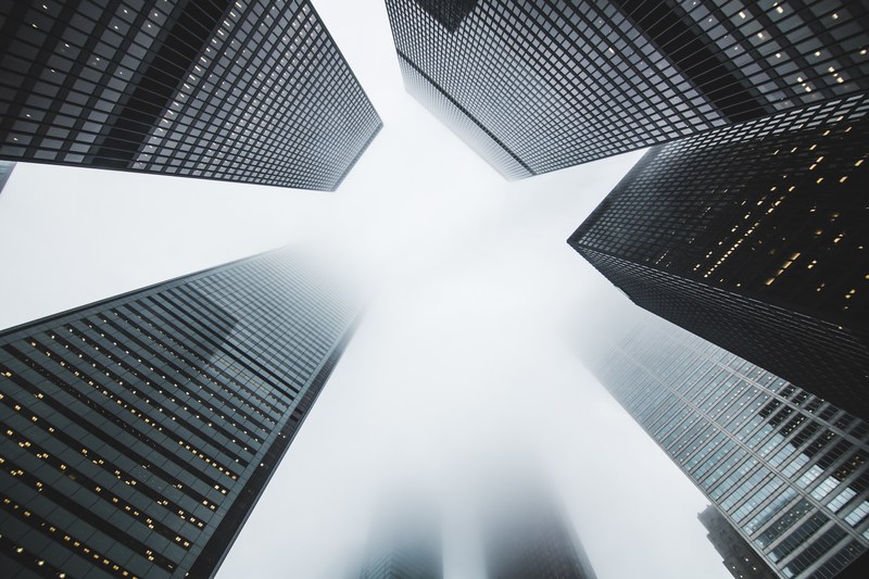 a low angle shot of dark skyscrapers on a foggy day, foggy skyscrapers 4k