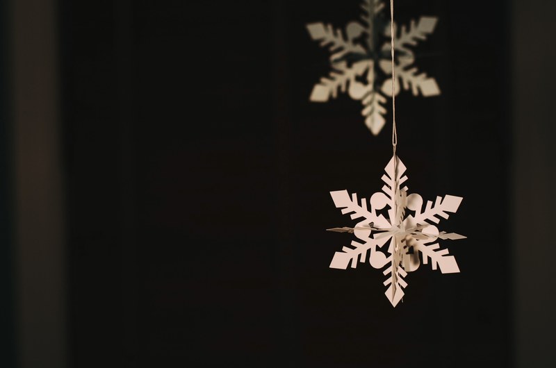 macro of christmas snowflake paper decorations hanging in front of black background brookline, paper snowflakes 4k