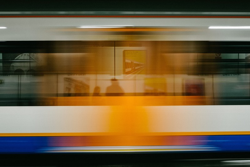 a blurry shot of a rapidly moving train, speedy subway train 4k