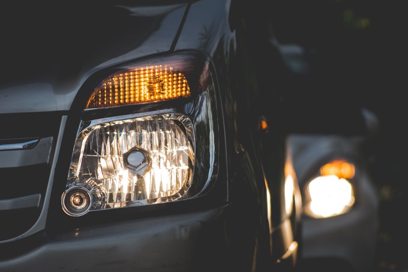 two car headlights one behind the other seen at night, night traffic lights 4k