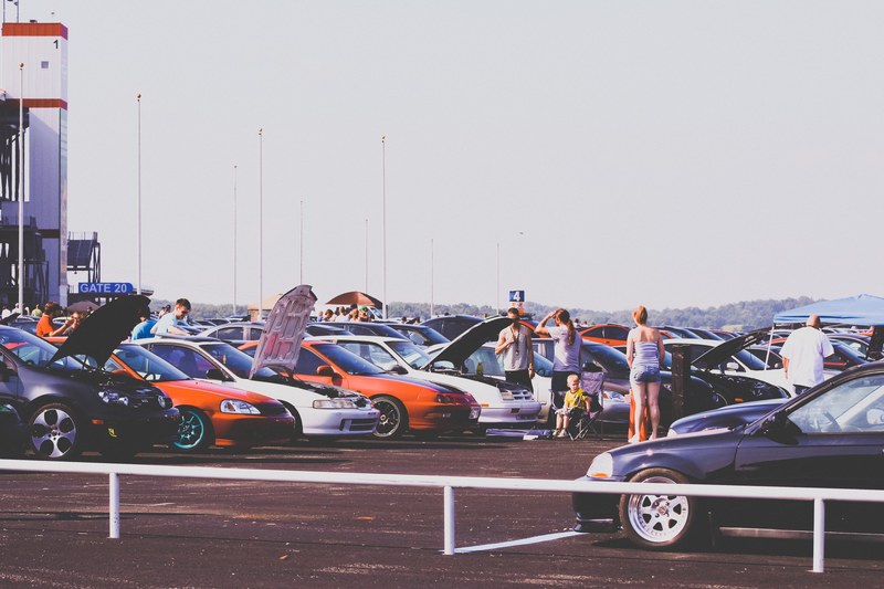 people looking at cars parked in parking lot at a car show, people at car show 4k
