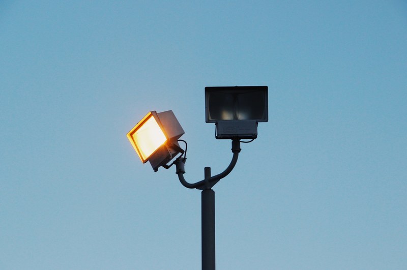 a rectangular spot light on a post next to another unlit lamp, wink 4k