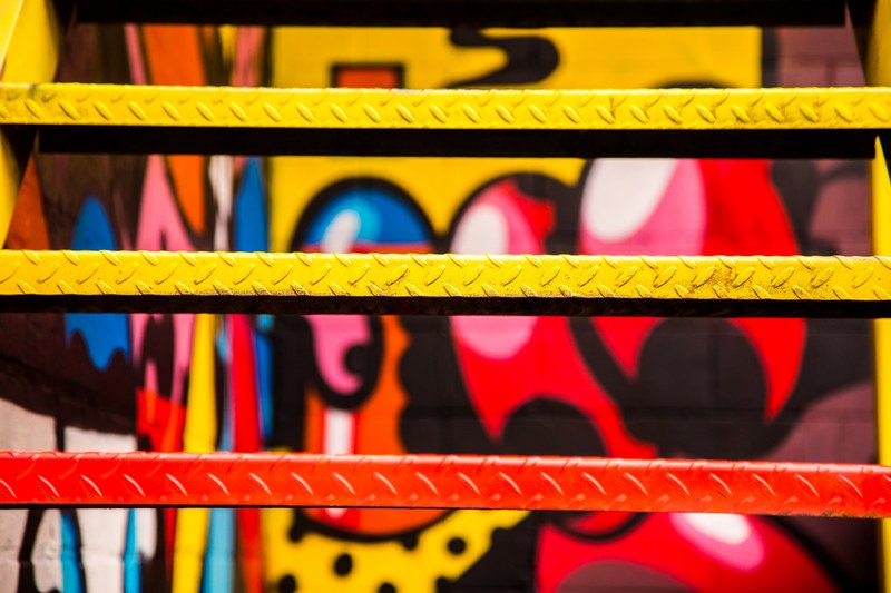 close up of spray painted metal urban stairs with colorful graffiti in background windsor, color stairs 4k