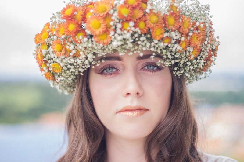 a woman in a large crown of white and orange flowers, impressive flower crown 4k