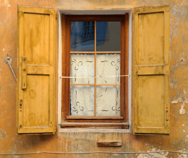 an open wooden glass window covered with a white sheet showing the reflection of another window of blue color, _history in every footstep 4k