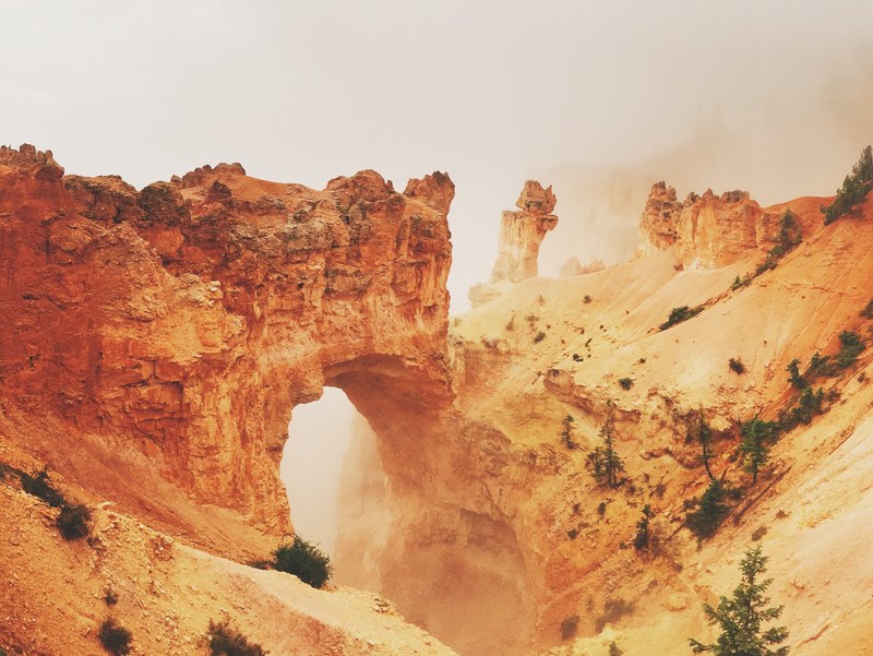 aerial drone shot of fog over deserted bryce canyon national park, misty desert formations 4k
