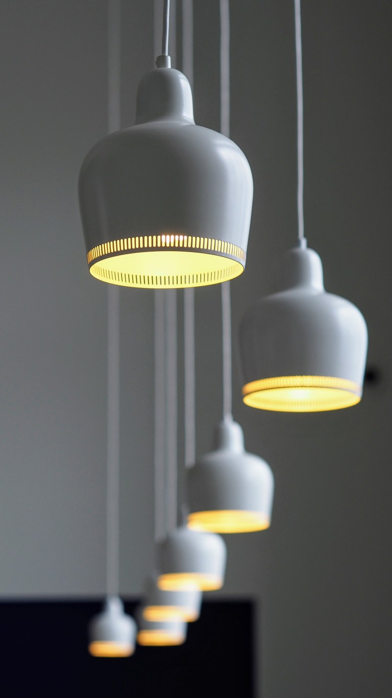 white porcelain lamps hanging from a ceiling on long wires, alvar aalto lamps 4k