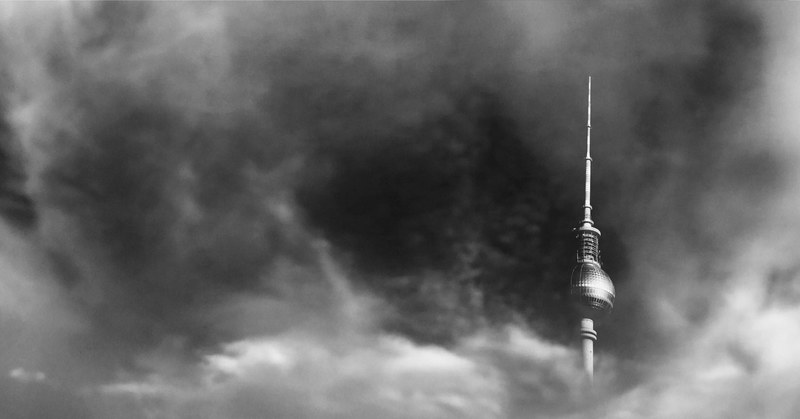the fernsehturm tower in berlin shrouded in gray clouds, television tower in gray 4k