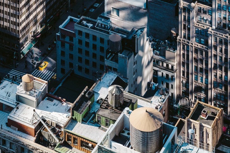 a high view of apartment building roofs in manhattan, drone manhattan shadow 4k
