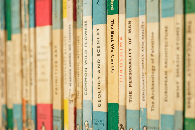 a bookshelf filled with old books, classic mid century penguin books 1 of 2 4k