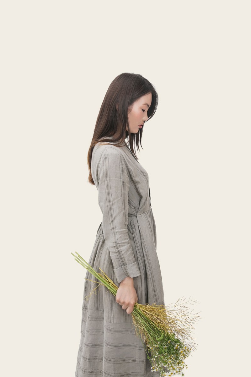 an asian woman with her head down wearing gray clothes and holding flowers, _asian girl with a bouquet 4k
