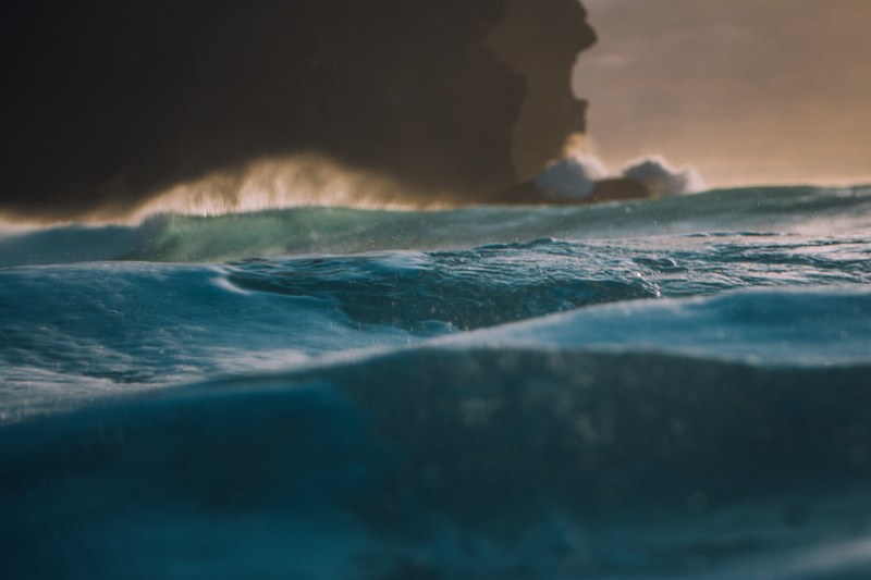 the blue sea starting to get choppy as a dark storm cloud looms in the distance at piha, here comes the storm 4k