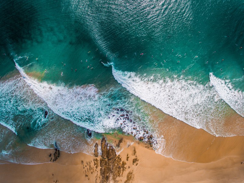 drone aerial view of the waves crashing on the sand beach at snapper rocks road, snapper rocks 4k